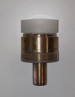 FIGURE 1. An aspheric lens is mounted on a brass arbor.