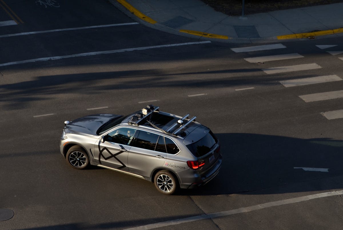 FIGURE 1. Four Blackmore lidar sensors are mounted atop a BMW X5 test vehicle on the road.