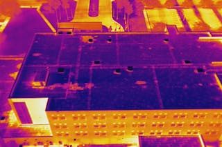 FIGURE 3. Building inspection, especially for thermal leaks and hot spots, is an important application for LWIR imaging. Here, a FLIR Tau camera takes an aerial thermal video of the roof of a building. The camera is part of FLIR&rsquo;s Zenmuse XT gimbal-mounted thermal imager, which here is mounted on an aerial drone.