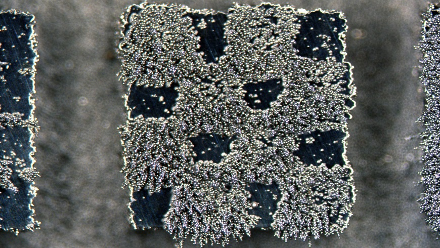 A 4 &times; 4 mm miniature steel chessboard with squares that are alternately magnetic and nonmagnetic was fabricated using 3D laser printing, with magnetic properties determined during fabrication by changing the laser beam properties. Here, iron filings stick to the magnetic regions.