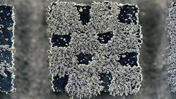 A 4 × 4 mm miniature steel chessboard with squares that are alternately magnetic and nonmagnetic was fabricated using 3D laser printing, with magnetic properties determined during fabrication by changing the laser beam properties. Here, iron filings stick to the magnetic regions. A 4 × 4 mm miniature steel chessboard with squares that are alternately magnetic and nonmagnetic was fabricated using 3D laser printing, with magnetic properties determined during fabrication by changing the laser beam properties. Here, iron filings stick to the magnetic regions.