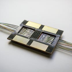 FIGURE 3. Rockley Photonics’ prototype optoASIC comprises a Layer-3 routing ASIC with 12 100 Gbit/s Ethernet ports, analog driver and receiver circuits, and silicon PICs with optical modulators and photodetectors supporting parallel single-mode fiber. Light sources are external to the device; optical power is delivered to the transmit PICs via additional input fibers. The total power per 100G port, including lasers, is under 3 W—lower than the typical power of a QSFP28 transceiver alone, yet including the switching functionality. FIGURE 3. Rockley Photonics’ prototype optoASIC comprises a Layer-3 routing ASIC with 12 100 Gbit/s Ethernet ports, analog driver and receiver circuits, and silicon PICs with optical modulators and photodetectors supporting parallel single-mode fiber. Light sources are external to the device; optical power is delivered to the transmit PICs via additional input fibers. The total power per 100G port, including lasers, is under 3 W—lower than the typical power of a QSFP28 transceiver alone, yet including the switching functionality.