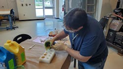 John Anderson, LASER-TEC technologist, manufactures laser stands using resin and rubber-silicon casting. The stands will be part of the Light and Optics Experiment Kits (LOEKs) manufactured by the LASER-TEC Center housed at Indian River State College. The kits provide every student in The Optics and Photonics College Network (OPCN) nationwide with a kit allowing them to conduct experiments required to complete their laboratories from the safety of their homes during the COVID-19 pandemic. The LASER-TEC Center has sent 116 kits to students at 11 colleges across the country. John Anderson, LASER-TEC technologist, manufactures laser stands using resin and rubber-silicon casting. The stands will be part of the Light and Optics Experiment Kits (LOEKs) manufactured by the LASER-TEC Center housed at Indian River State College. The kits provide every student in The Optics and Photonics College Network (OPCN) nationwide with a kit allowing them to conduct experiments required to complete their laboratories from the safety of their homes during the COVID-19 pandemic. The LASER-TEC Center has sent 116 kits to students at 11 colleges across the country.