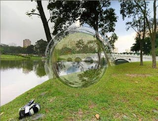 Beginning with a scene of the Chinese Garden in Singapore, a polarization-dependent invisible sphere is depicted as it would appear in unpolarized light.