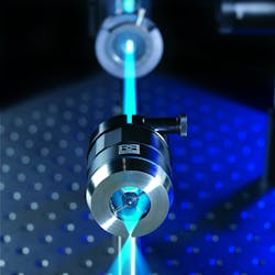FIGURE 2. Fixed reflective objectives such as the one shown here focusing a high-power blue laser beam in a biomedical application can be simpler, more rugged, and more compact than their lens-based equivalents.
