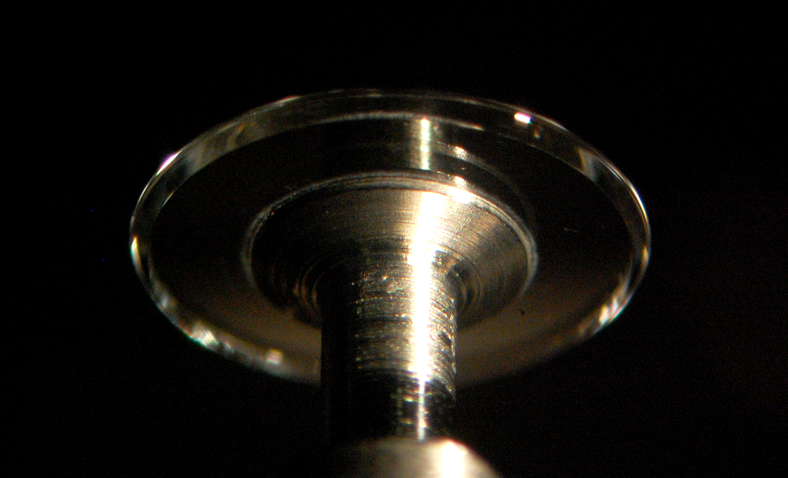 A crystalline WGM microresonator made of CaF2 has an unloaded Q factor of 2 &times; 109. Its extremely high Q results in significant surface Rayleigh backscattering (the lower the losses elsewhere, the more important becomes the Rayleigh scattering), allowing the resonator to be coupled to a distributed-feedback semiconductor laser. The result is a narrowing of the laser's linewidth to less than 200 Hz.