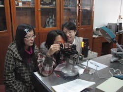 FIGURE 3. Students at Tianjin University in China perform an optics experiment.