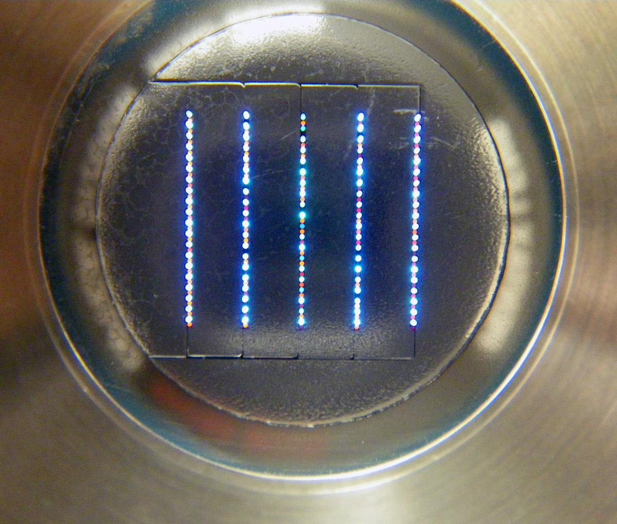 FIGURE 2. An optical-mechanical connection to entrance slits of a McPherson spectrometer contains 100 signal fibers. This fiber array is actually made of 200 fibers, with alternate fibers illuminated for discrete spectrometer imaging.