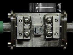FIGURE 2. Optics from Chiral Photonics are combined with OpSIS Foundry (University of Delaware; Newark, DE) photonic integrated-circuit technology to form a complete optoelectronics package with ultradense, low-insertion-loss optical I/O. FIGURE 2. Optics from Chiral Photonics are combined with OpSIS Foundry (University of Delaware; Newark, DE) photonic integrated-circuit technology to form a complete optoelectronics package with ultradense, low-insertion-loss optical I/O.