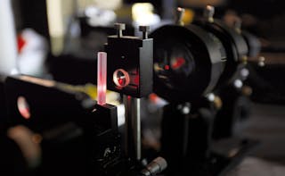 FIGURE 2. Phosphate laser glass is shown in an end-pumped laser cavity undergoing performance testing.
