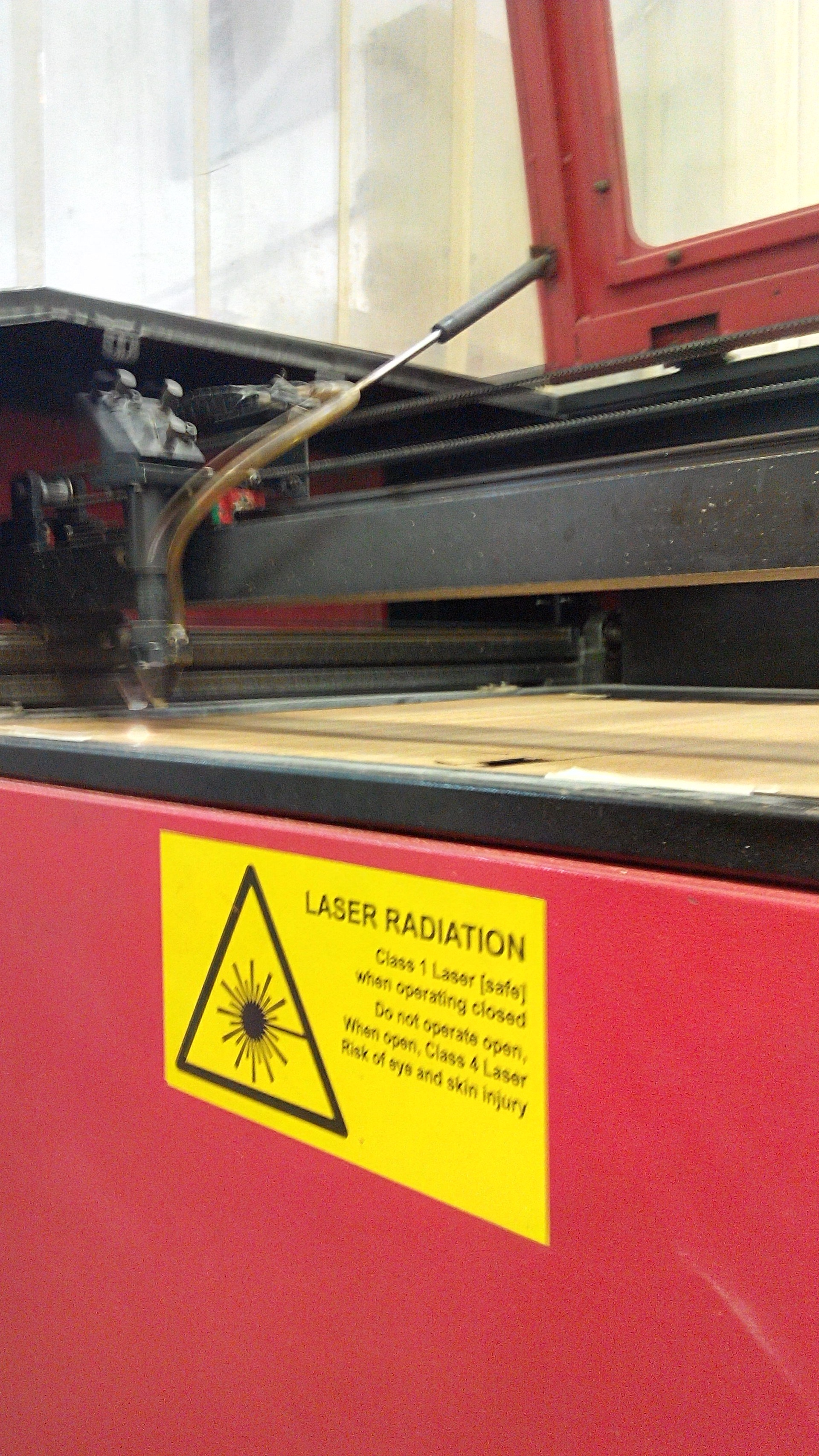 FIGURE 4. A laser-safety label details the specific setup of the laser to which it is affixed: a class I (safe) laser when closed, but a class 4 (high-power, unsafe) laser when open.