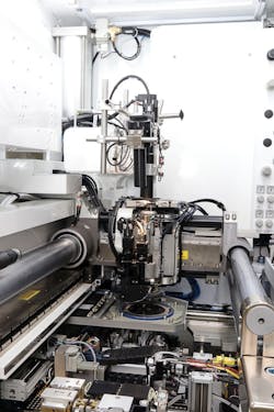 FIGURE 5. MRSI-H-TO bonding header picking up die from a wafer. FIGURE 5. MRSI-H-TO bonding header picking up die from a wafer.