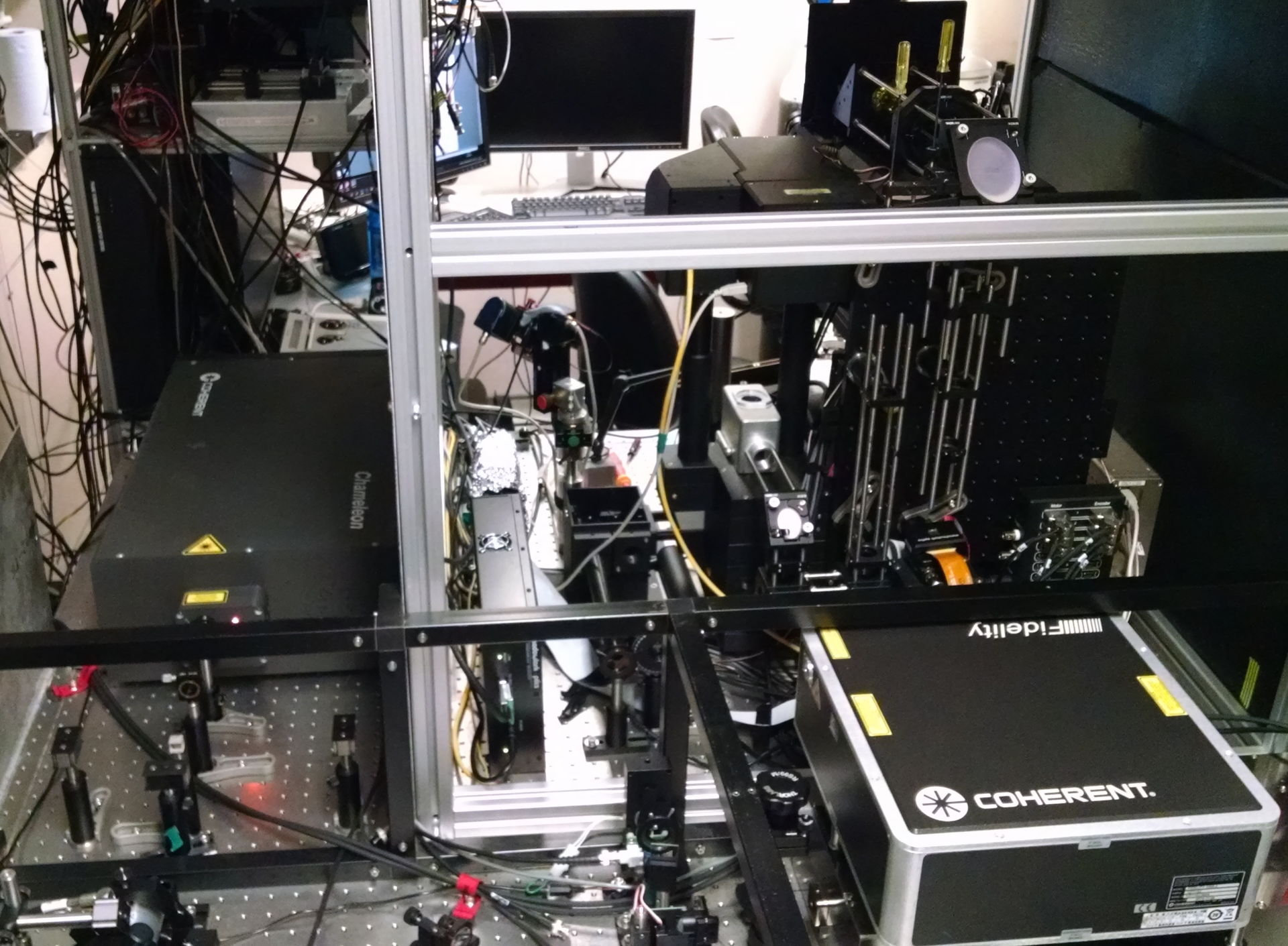 Optogenetics microscopy setup: A ytterbium fiber laser (Coherent Fidelity), which is used primarily for photoactivation, is used in conjunction with a tunable ultrafast laser (Coherent Chameleon; background).