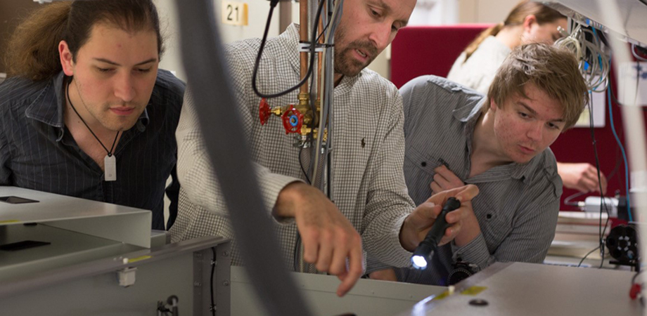 Daniele Faccio of the University of Glasgow, center, works on laser system alignment and optimization with student Mihail Petev, left, and Niclas Westerberg, a Leverhulme fellow in the School of Physics and Astronomy.