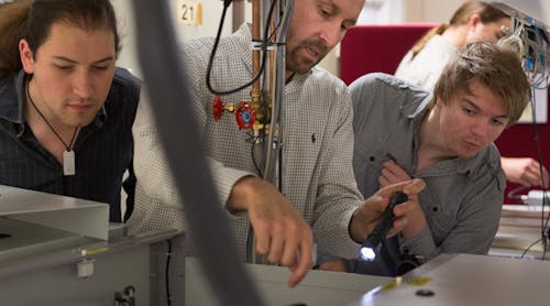 Daniele Faccio of the University of Glasgow, center, works on laser system alignment and optimization with student Mihail Petev, left, and Niclas Westerberg, a Leverhulme fellow in the School of Physics and Astronomy.