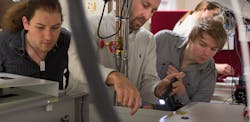 Daniele Faccio of the University of Glasgow, center, works on laser system alignment and optimization with student Mihail Petev, left, and Niclas Westerberg, a Leverhulme fellow in the School of Physics and Astronomy. Daniele Faccio of the University of Glasgow, center, works on laser system alignment and optimization with student Mihail Petev, left, and Niclas Westerberg, a Leverhulme fellow in the School of Physics and Astronomy.