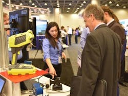 An exhibitor gives a product demonstration on the SPIE BiOS 2016 show floor.