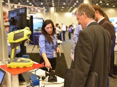 An exhibitor gives a product demonstration on the SPIE BiOS 2016 show floor.