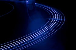 A main amplifier fiber similar to the fiber used in the paper, but a little longer, glows during operation (the blue color is due to a camera filter; unfiltered, the fiber appears green while operating). A main amplifier fiber similar to the fiber used in the paper, but a little longer, glows during operation (the blue color is due to a camera filter; unfiltered, the fiber appears green while operating).