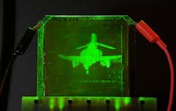 A refreshable holographic image of an F-4 Phantom jet is created on a photorefractive polymer. A refreshable holographic image of an F-4 Phantom jet is created on a photorefractive polymer.