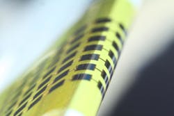 Ultrathin photovoltaic cells made of gallium arsenide (GaAs) with a vertical structure are flexible enough to bend around small objects, such as the 1-mm-thick edge of the glass slide shown here. Ultrathin photovoltaic cells made of gallium arsenide (GaAs) with a vertical structure are flexible enough to bend around small objects, such as the 1-mm-thick edge of the glass slide shown here.