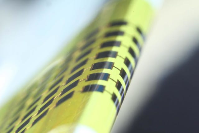 Ultrathin photovoltaic cells made of gallium arsenide (GaAs) with a vertical structure are flexible enough to bend around small objects, such as the 1-mm-thick edge of the glass slide shown here.