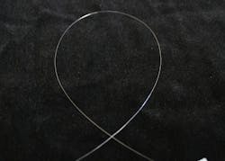 Unclad Yb:YAG single-crystal fiber (SCF) has a diameter of only 100 μm and demonstrates pure waveguided laser operation. Unclad Yb:YAG single-crystal fiber (SCF) has a diameter of only 100 μm and demonstrates pure waveguided laser operation.