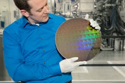 FIGURE 3. IBM Research scientist Nicolas Loubet holds a wafer of chips with 5 nm silicon nanosheet transistors. FIGURE 3. IBM Research scientist Nicolas Loubet holds a wafer of chips with 5 nm silicon nanosheet transistors.