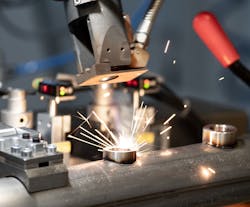 FIGURE 3. The FLC machine welds a sensor boss in place. FIGURE 3. The FLC machine welds a sensor boss in place.