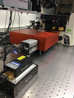 FIGURE 3. Advantages of a compact multi-line laser in a lab environment are space saving, reduced complexity, and reduced need for service and intervention; this type of laser is shown in use in the Department of Biotechnology & Biophysics at Julius-Maximilian-University of Würzburg. FIGURE 3. Advantages of a compact multi-line laser in a lab environment are space saving, reduced complexity, and reduced need for service and intervention; this type of laser is shown in use in the Department of Biotechnology & Biophysics at Julius-Maximilian-University of Würzburg.