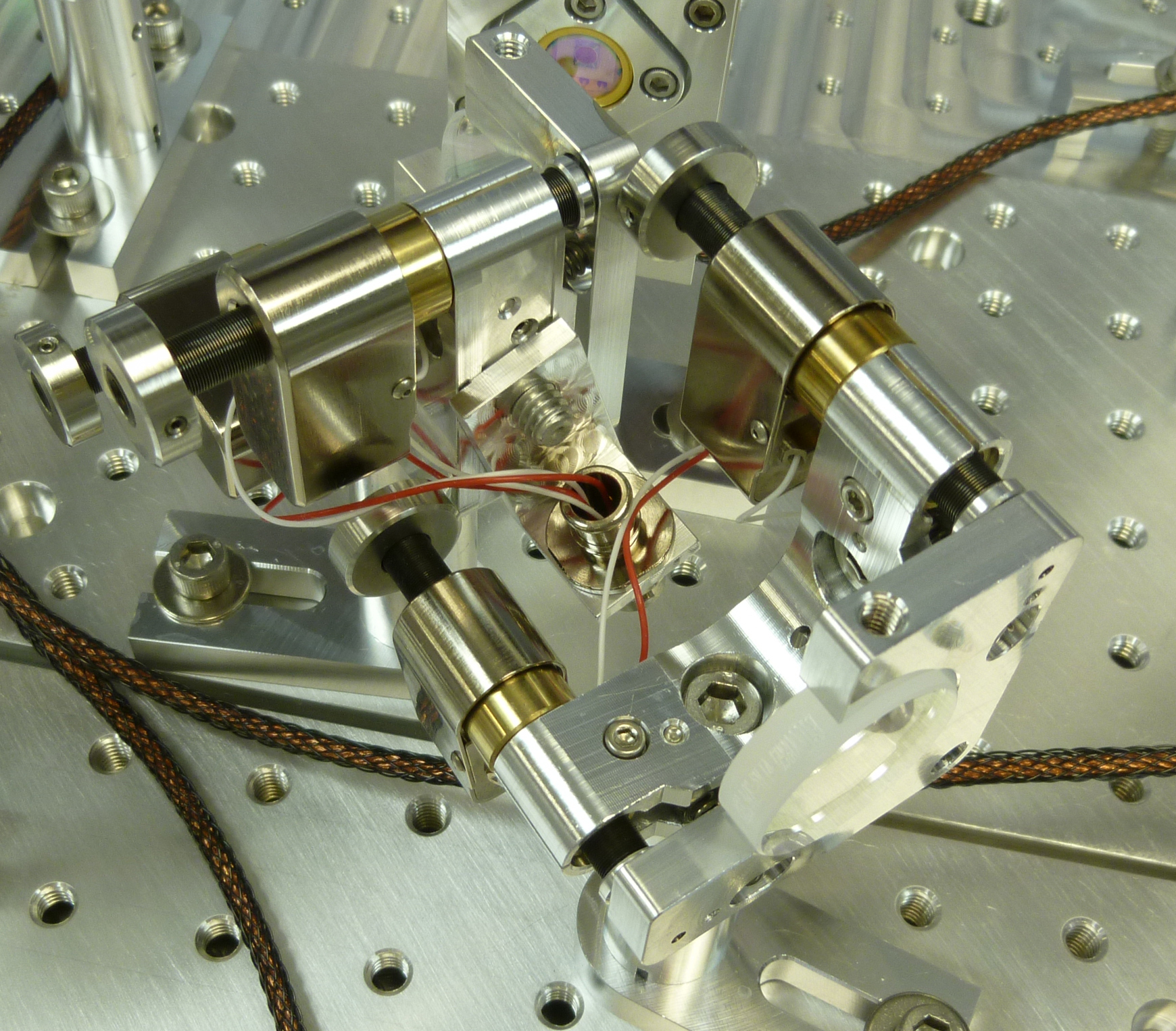 FIGURE 1. New Focus UHV Picomotor actuators are used in the Laser Interferometer Gravitational Wave Observatory (LIGO) as part of the Transmission Monitor Suspended Optical Bench. This platform will monitor the light transmitted through the End Test Mass. The actuators will enable control of precision alignment from outside one of the world's largest vacuum systems.