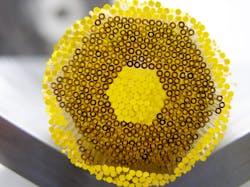 FIGURE 4. A macro-structured preform is obtained by manually assembling solid double-glass rods. FIGURE 4. A macro-structured preform is obtained by manually assembling solid double-glass rods.
