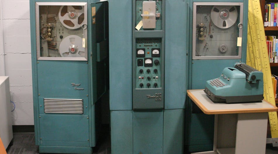 FIGURE 1. Bendix G15 was an early vacuum tube computer with 450 vacuum tubes and 300 germanium diodes. The main unit is in the middle; tape drives are to the sides. Control was through the digital typewriter at right.
