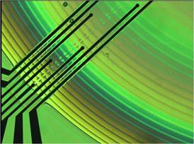 Electrical connections to electrodes in a liquid crystal enable eyeglass lenses to be reprogrammed for different prescriptions in real time.