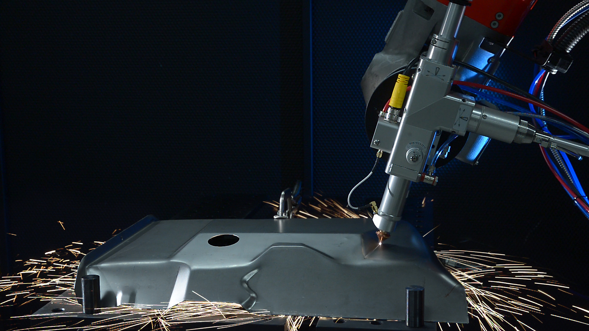 FIGURE 5. A Coherent Highlight FL fiber laser can be combined with robotics to enable high-speed 3D part cutting for industries such as white goods (washing machines, kitchen stoves, and so on).