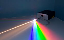 FIGURE 2. A commercial supercontinuum laser, with the main white light beam going through a diffraction grating to separate the visible spectrum (IR spectrum also there, but invisible). Commercial systems are turnkey and stable sources of ultra-broadband spectrum generated by a PCF pumped by an ultrafast fiber laser.