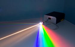 FIGURE 2. A commercial supercontinuum laser, with the main white light beam going through a diffraction grating to separate the visible spectrum (IR spectrum also there, but invisible). Commercial systems are turnkey and stable sources of ultra-broadband spectrum generated by a PCF pumped by an ultrafast fiber laser. FIGURE 2. A commercial supercontinuum laser, with the main white light beam going through a diffraction grating to separate the visible spectrum (IR spectrum also there, but invisible). Commercial systems are turnkey and stable sources of ultra-broadband spectrum generated by a PCF pumped by an ultrafast fiber laser.