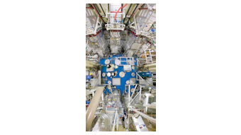 FIGURE 1. The Lawrence Livermore National Laboratory (LLNL) National Ignition Facility (NIF) target chamber; for scale, note worker in yellow helmet at left middle of photo.