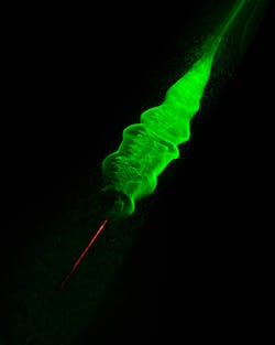 An 800 nm femtosecond-laser beam causes water vapor to condense in a cloud chamber; the resulting droplets scatter light from a second laser emitting at 532 nm.