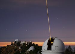 FIGURE 2. The guidestar laser beam is launched from the side of the Shane telescope. The artificial guidestar creates a point source of light in the mesosphere and can be placed wherever desired, opening up the whole sky to the sharpness of AO-corrected imaging.