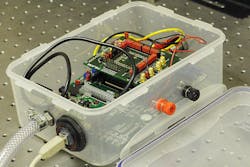 A lunchbox-sized (20 × 13 × 7 cm3) explosive-vapor-detection system measures fluorescent photoluminescence decay from a thin-film photoemissive polymer material using a CMOS-based detection system. A lunchbox-sized (20 × 13 × 7 cm3) explosive-vapor-detection system measures fluorescent photoluminescence decay from a thin-film photoemissive polymer material using a CMOS-based detection system.