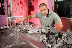 Researcher Ali Hussain adjusts a dual-laser setup that measures isotope ratios. Designed for use on Mars, the system is being adapted to measure samples of common foods to pinpoint their geographic origin.
