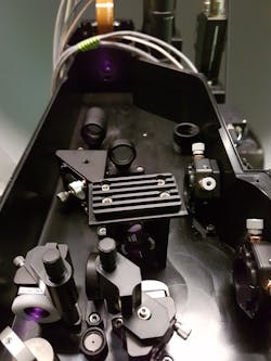 FIGURE 3. The light path of the stimulation laser, with spatial modulator that shapes the beam into a pattern that effectively activates the target population of neurons, indicated by yellow circles shown in the figure at the top of this page. FIGURE 3. The light path of the stimulation laser, with spatial modulator that shapes the beam into a pattern that effectively activates the target population of neurons, indicated by yellow circles shown in the figure at the top of this page.