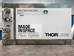 FIGURE 3. The microwave-sized instrument shown was the first Made In Space Fiber Optics payload to go to the International Space Station. FIGURE 3. The microwave-sized instrument shown was the first Made In Space Fiber Optics payload to go to the International Space Station.