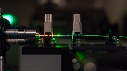 FIGURE 1. When a random laser is filled with a gain medium and then pumped with a single-colored laser, microscopic air channels in the optical fiber make the output beam highly directional and stabilize its spectrum.