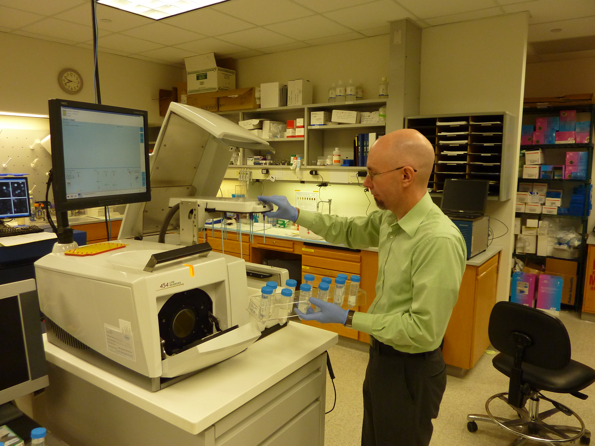 FIGURE 1. Scott Hunicke-Smith loads samples in a 454 Life Science sequencer.