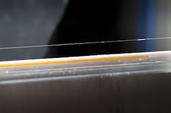 FIGURE 2. Randy Heflin and Tom Inzana’s biosensor uses an optical fiber that contains a long-period grating and is coated with self-assembled layers of polymer and an affinity coating for a total thickness of about 20 nm. FIGURE 2. Randy Heflin and Tom Inzana’s biosensor uses an optical fiber that contains a long-period grating and is coated with self-assembled layers of polymer and an affinity coating for a total thickness of about 20 nm.