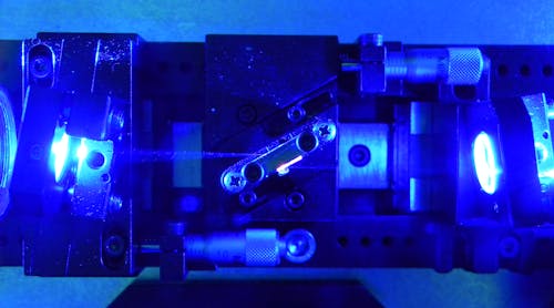FIGURE 1. The Brewster-cut Ti:sapphire crystal shows the tight focus from the blue pump diodes.