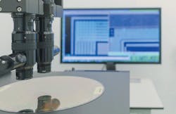FIGURE 1. Silicon wafer undergoing inspection. FIGURE 1. Silicon wafer undergoing inspection.