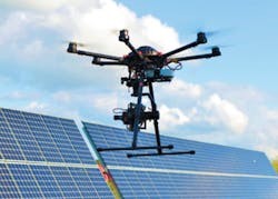 FIGURE 3. Vis-SWIR camera on a drone inspecting photovoltaic (PV) panels on a solar farm. FIGURE 3. Vis-SWIR camera on a drone inspecting photovoltaic (PV) panels on a solar farm.
